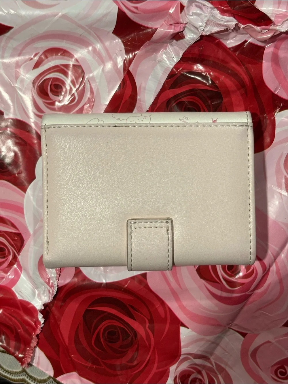 Adorable rabbit-print kids wallet in light pink and white. Durable faux leather
